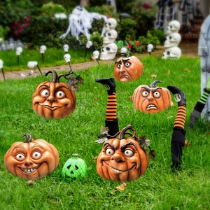 Detail showing five expressive Halloween pumpkins with striped legs on a green lawn