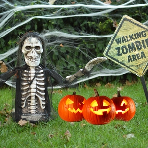 Detailed Halloween garden decor set featuring skeletal zombie figure and glowing jack-o'-lanterns