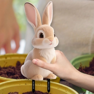 Inserting a realistic rabbit PVC garden stake into a flower pot for outdoor decoration