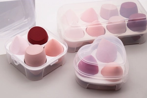 Detail view of pink makeup sponge set in clear storage boxes showing different sponge shapes
