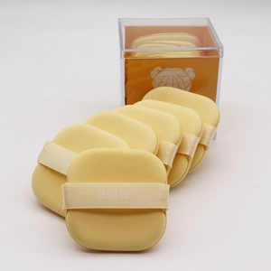 Set of 5 butter-yellow cushion puffs in a clear acrylic storage case for makeup application