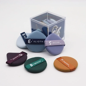 Detailed view of six colorful soft makeup cushion puffs stored in a clear acrylic box