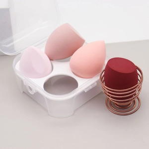 Set of 4 makeup sponges in a plastic storage box with a rose gold drying stand