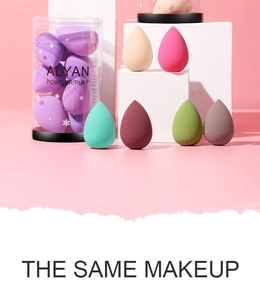 Macro view of multi-colored teardrop makeup sponges with transparent storage cylinder