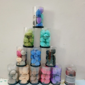 Stack of 10 mini colorful beauty blenders in a clear cylindrical storage container