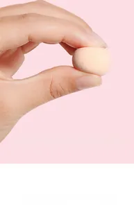 Close-up showing the elasticity and soft texture of a skin-toned makeup sponge