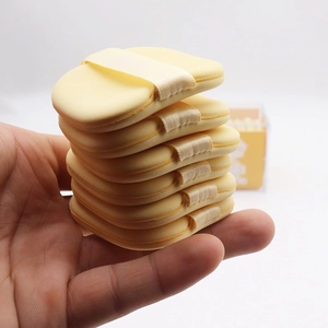 Set of 6 bright yellow square makeup sponges with finger straps in an acrylic box
