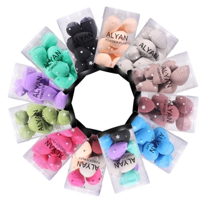 Set of 10 mini beauty blenders in various colors within transparent cylinder containers