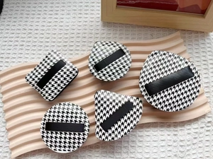 Set of five houndstooth makeup puffs in various shapes like water drop and triangle