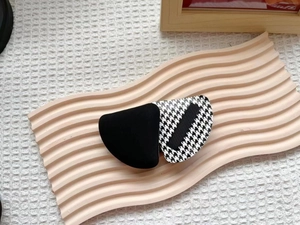 Houndstooth and velvet hair clip on a decorative tray for a vintage aesthetic look