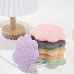 Macro detail of colorful cat paw shaped facial sponges in soft pastel macaron colors