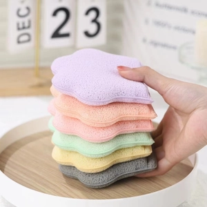Close-up of colorful star-shaped facial cleansing sponges in a wooden tray