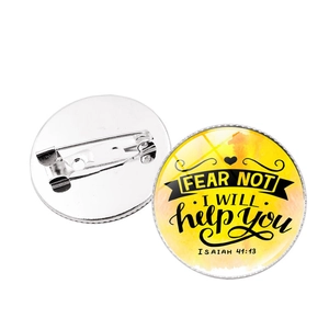 Detail view of the yellow inspirational round badge showing the pin back and front design