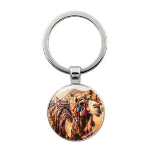 Macro detail of silver metal keychain featuring a desert camel art glass pendant