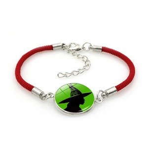 Detailed shot of red braided Elphaba witch silhouette charm bracelet with silver clasp