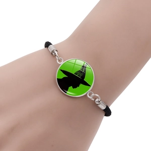 Handmade woven Elphaba Glinda charm bracelet with green witch silhouette pendant