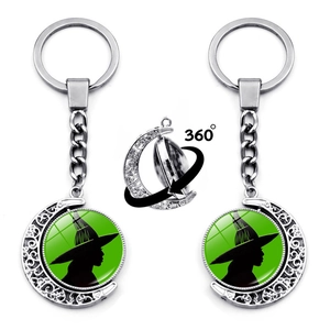 Detail of double-sided 360 rotating pendant with witch silhouette and crescent moon frame