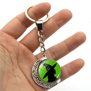 Gothic moon keychain with Wicked Elphaba green silhouette on a white background