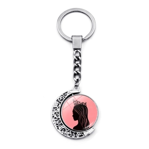Rotating crescent moon keychain with queen silhouette pendant in silver and pink finish