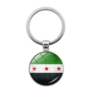 Polished metal keychain featuring circular Syrian Independence flag pendant on white back
