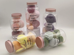 Various colorful makeup sponge set stored in a clear bottle with golden lid