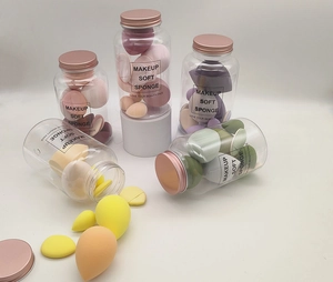 Detail of multi-colored makeup sponge set in a transparent bottle with rose gold screw lid
