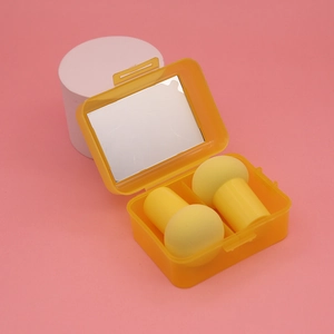 Orange portable storage box with mirror featuring two yellow mushroom makeup sponges