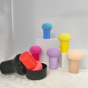 Detailed view of six colorful mushroom makeup sponges with handles in clear boxes