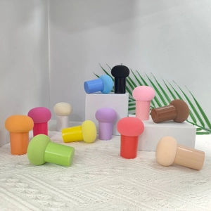 Detailed close-up of multi-colored mushroom head makeup sponges with ergonomic handles