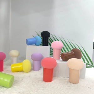 Colorful mushroom makeup sponge set with handles displayed on a white tiered stand
