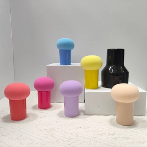 Detail of multi-colored mushroom head makeup sponges with handles in a tiered display