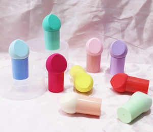 Detail of multi-colored mushroom head makeup sponges with handles on display stands