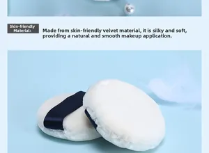 Close-up of white velvet powder puff with dark blue ribbon on a soft blue background