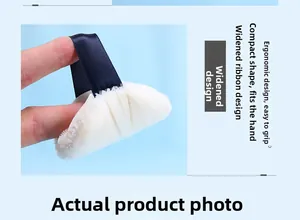 Macro detail of compact makeup puff showing the wide blue ribbon and plush white texture