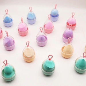 Detailed array of multi-colored makeup sponges in transparent egg-shaped hanging cases
