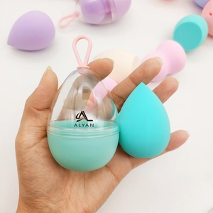 Mint green makeup sponge in egg-shaped storage box with portable silicone hanging strap