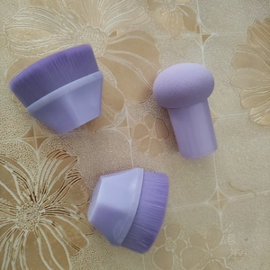 Detailed set of purple foundation brushes and a mushroom makeup sponge for smooth blending