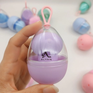 Macro detail of teardrop makeup sponge in purple with portable egg-shaped hanging case