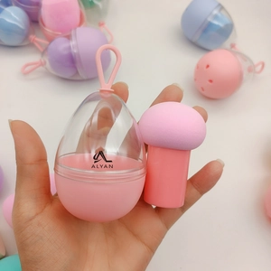 Pink mushroom makeup sponge with handle and egg-shaped storage case with pink hook