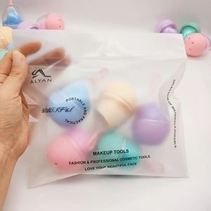 Detail of colorful makeup sponges in individual egg-shell cases and zipper bag packaging