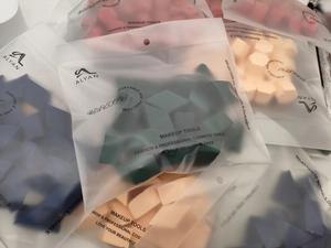 Macro detail of geometric makeup sponges in frosted zipper bags with various colors