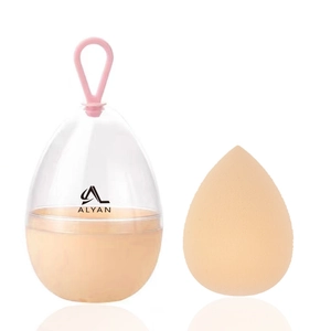 Detail of nude teardrop makeup sponge inside egg-shaped case with pink silicone handle
