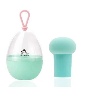 Detail of mint green mushroom makeup sponge with handle in transparent egg-shaped case