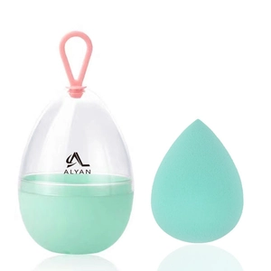 Detail of mint green teardrop makeup sponge and portable egg-shaped storage box case