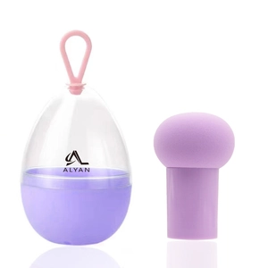 Macro view of purple mushroom makeup sponge and egg-shaped case with pink handle