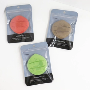Detailed view of three soft fruit-patterned makeup puffs in individual zipper bags