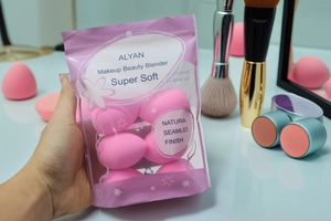 Detail of soft pink beauty sponges in a portable zip bag for flawless makeup application