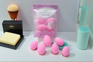 Close-up of super soft pink makeup sponge set with brand packaging and cosmetic tools