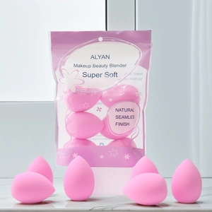 Detail of soft pink makeup sponges on marble background with breathable packaging