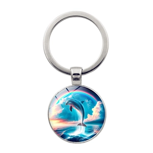 Detail of round silver keychain featuring a jumping dolphin and rainbow scenery